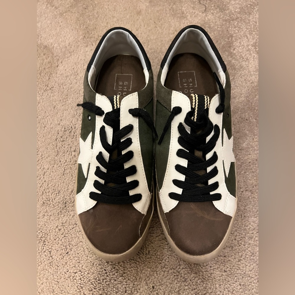 Hunter green, brown, and white sneakers